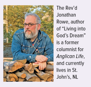 a man leans on stacked firewood, looking off to the left